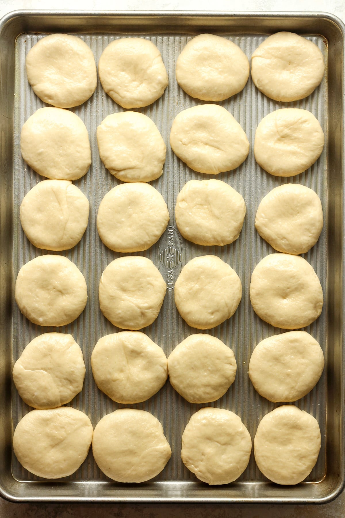 A pan of the kolache rolls after forming into 24 equal parts.