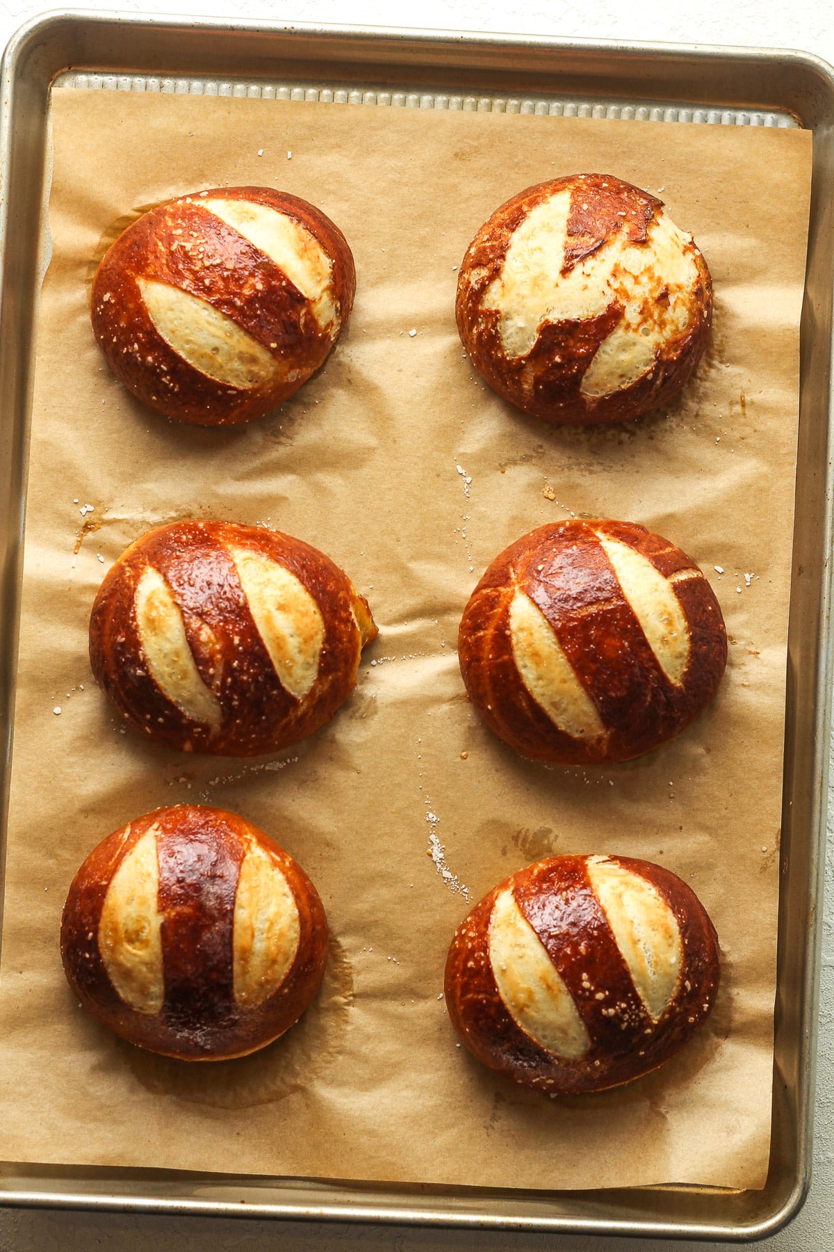 A pan with baked pretzel buns.