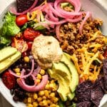 Closeup on a bowl of turkey taco salad with chipotle ranch dressing.