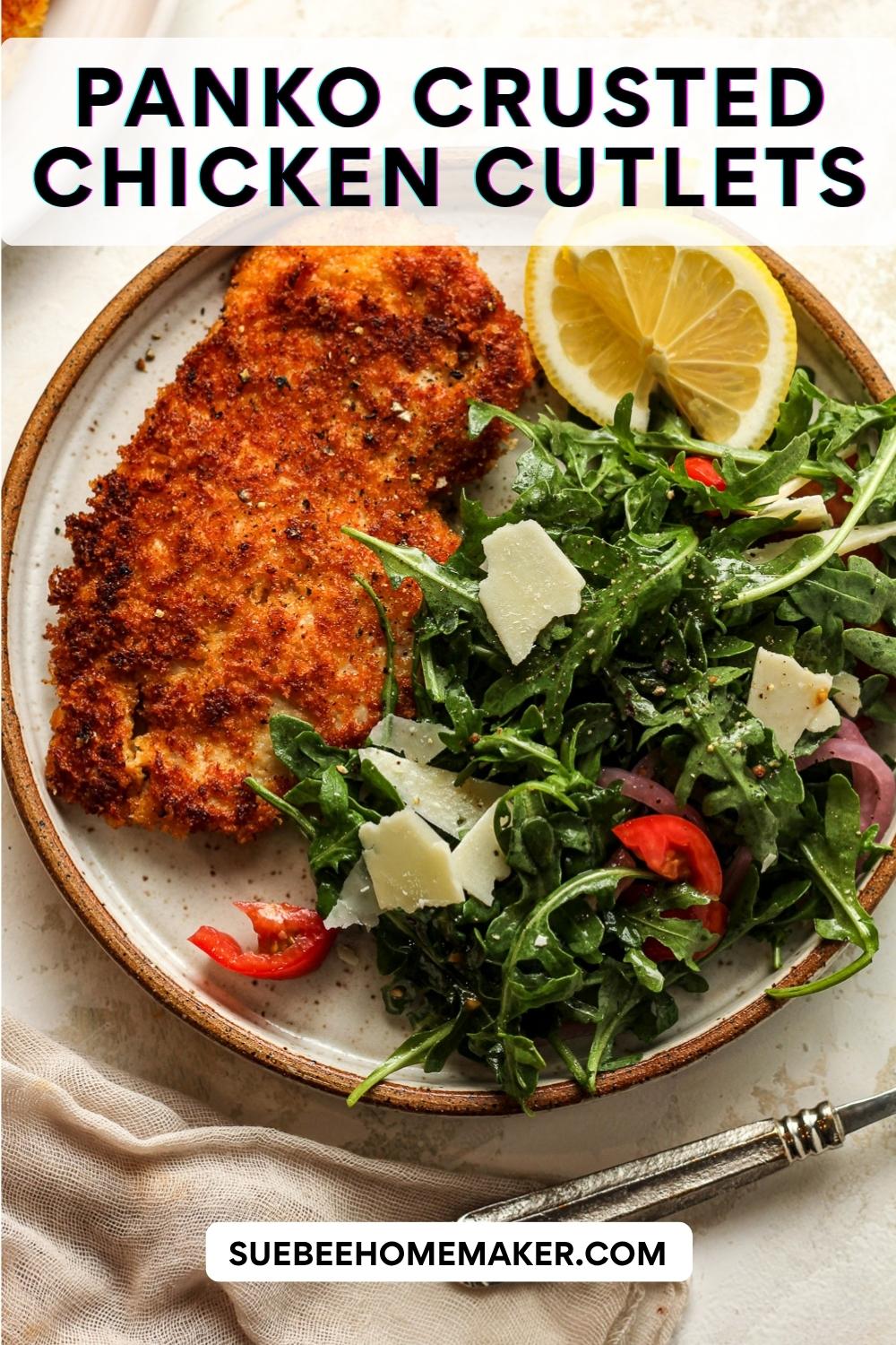 A plate of panko crusted chicken cutlet with arugula salad.