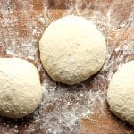 Closeup view on three rounds of homemade pizza dough.