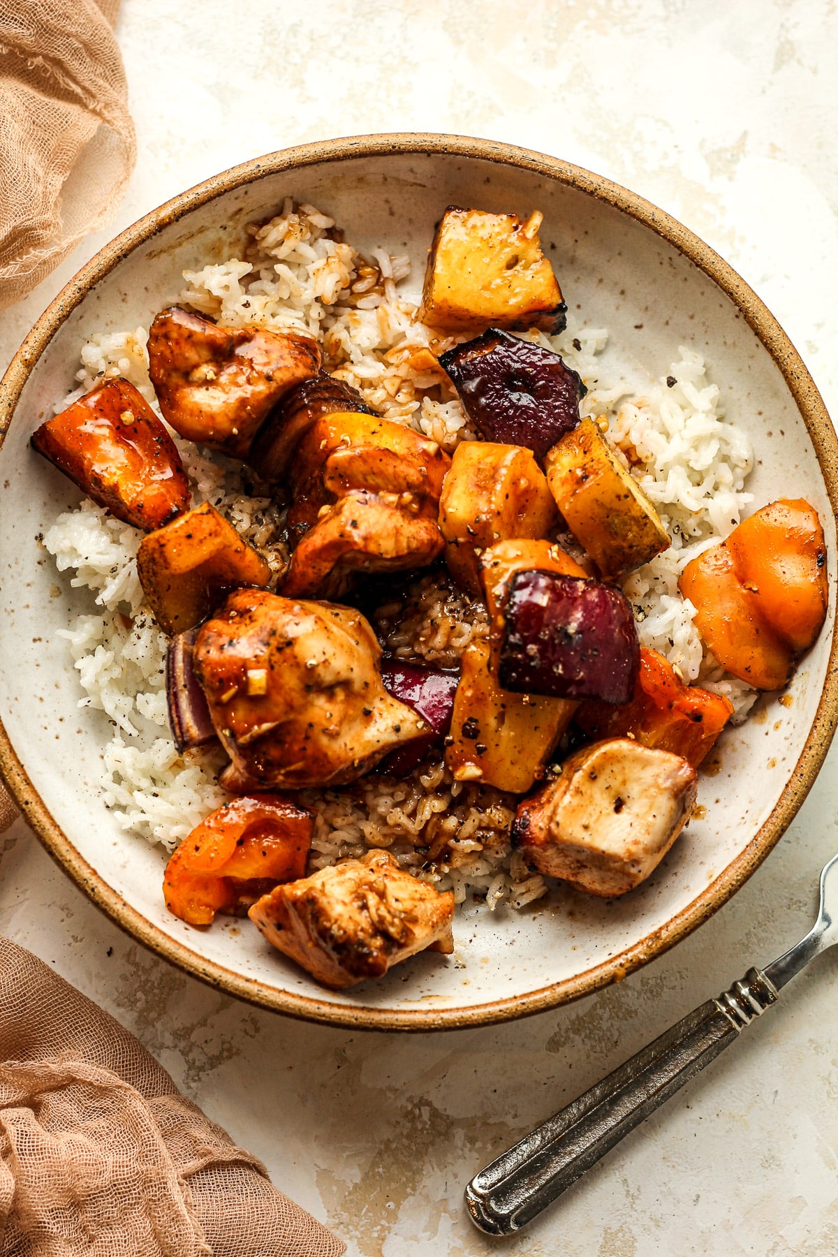 The bowl of kabobs with a fork beside it.