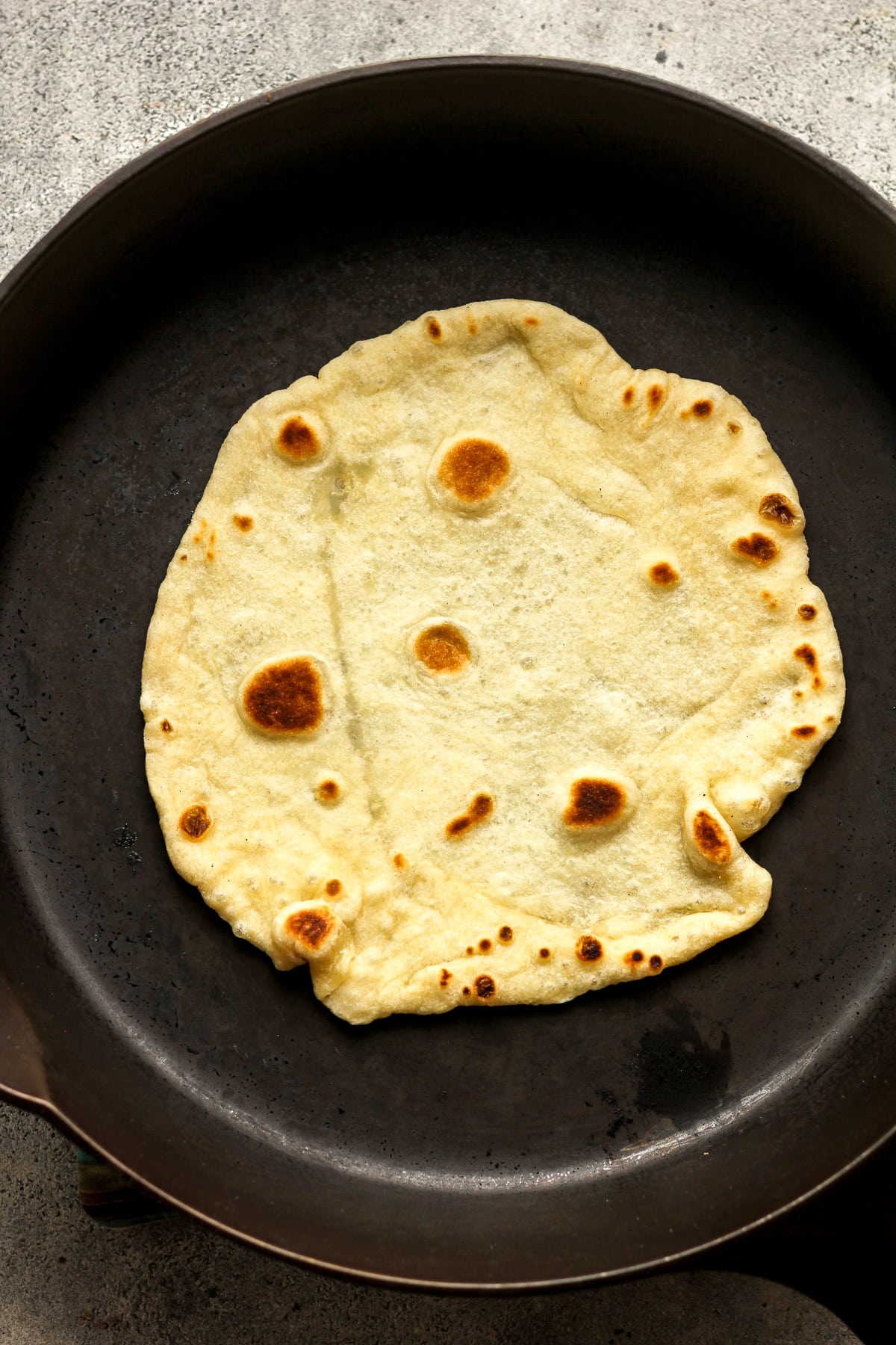 A skillet of a tortilla cooking.