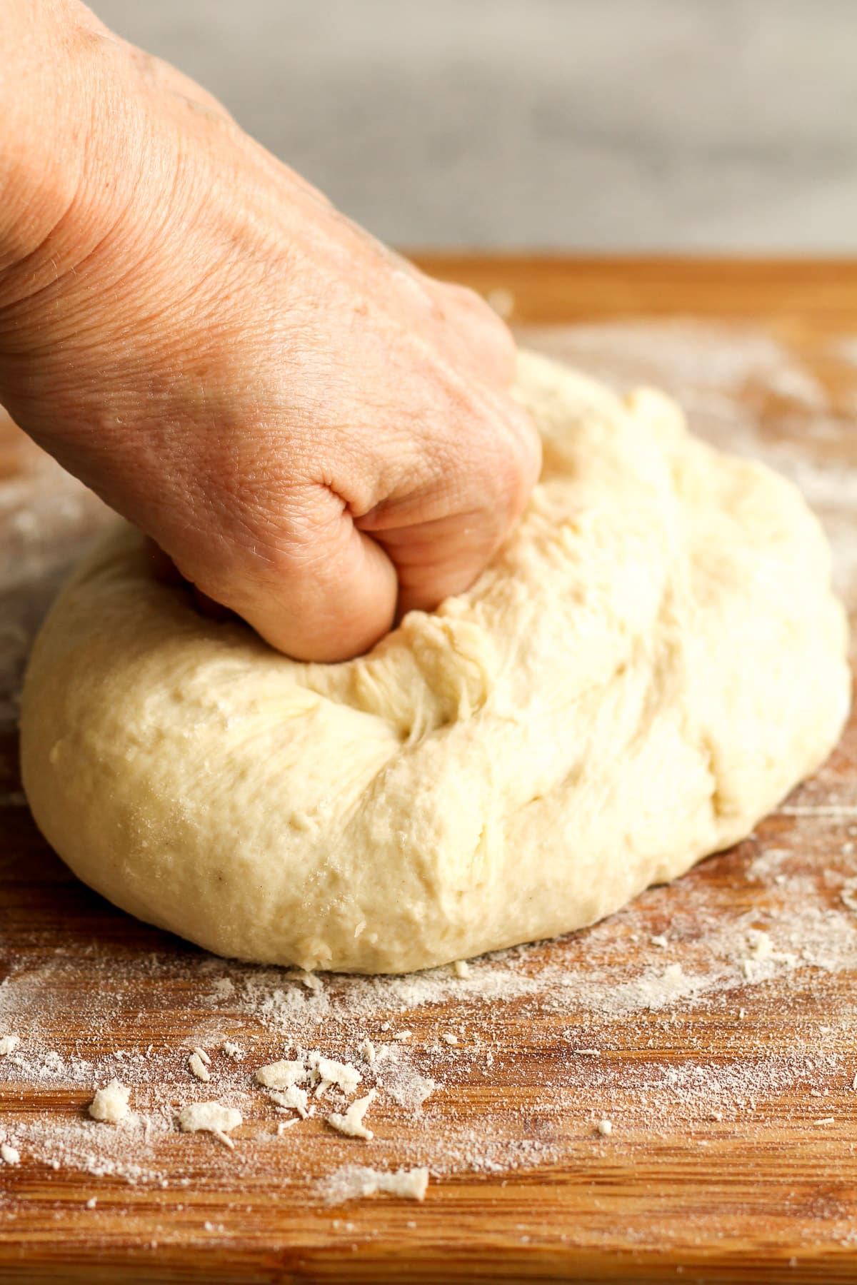 A hand kneading the tortilla dough.