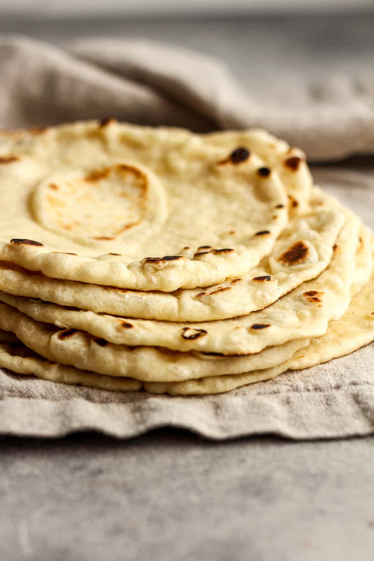 Side view of some stacked soft flour tortillas.