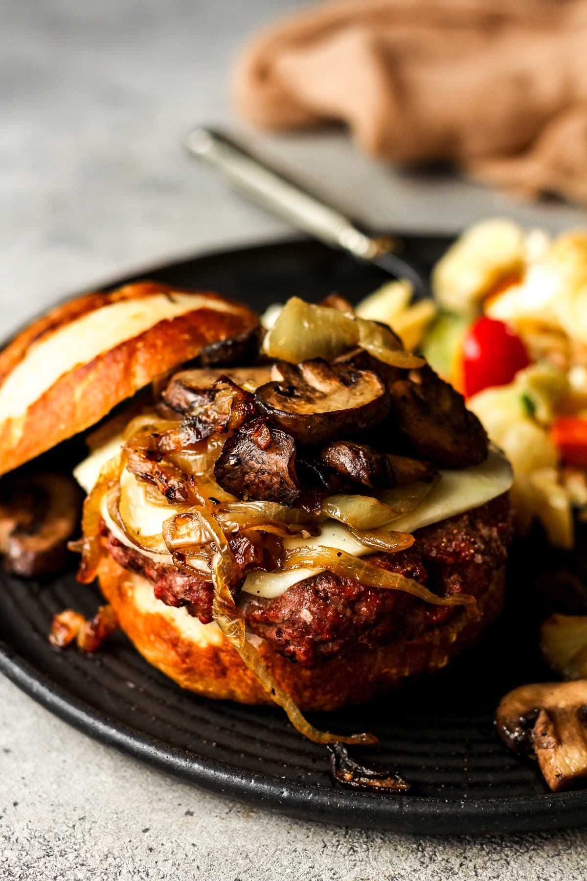 Side view of the dressed burger with the top bun off to the side.