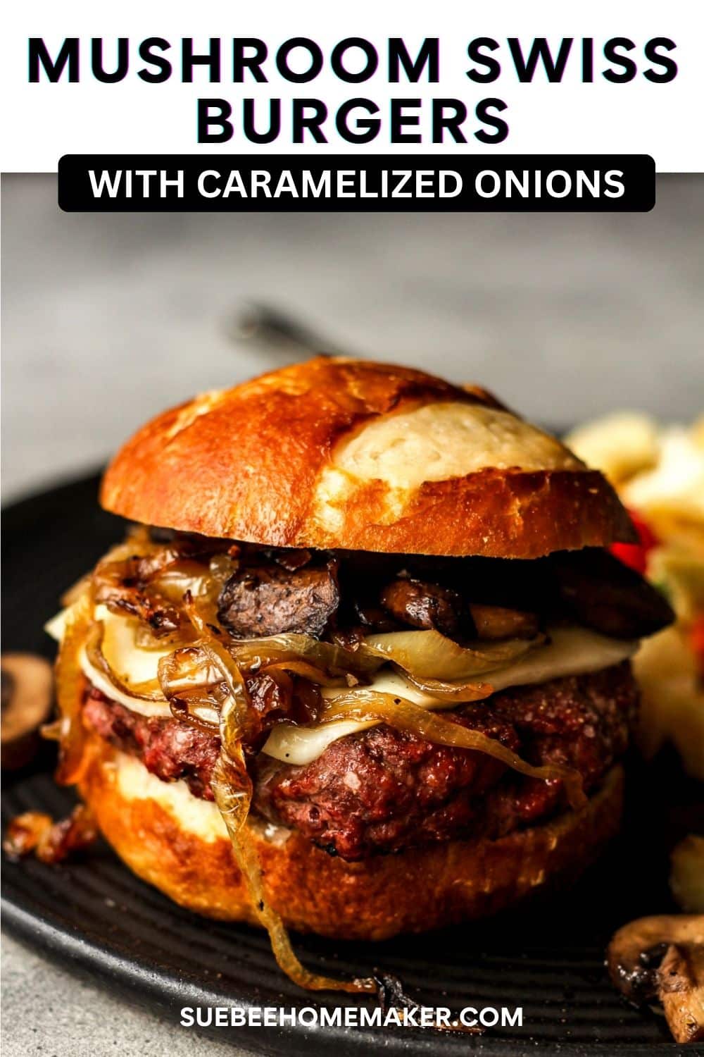 Side view of a mushroom swiss burger with caramelized onions - on a pretzel bun.