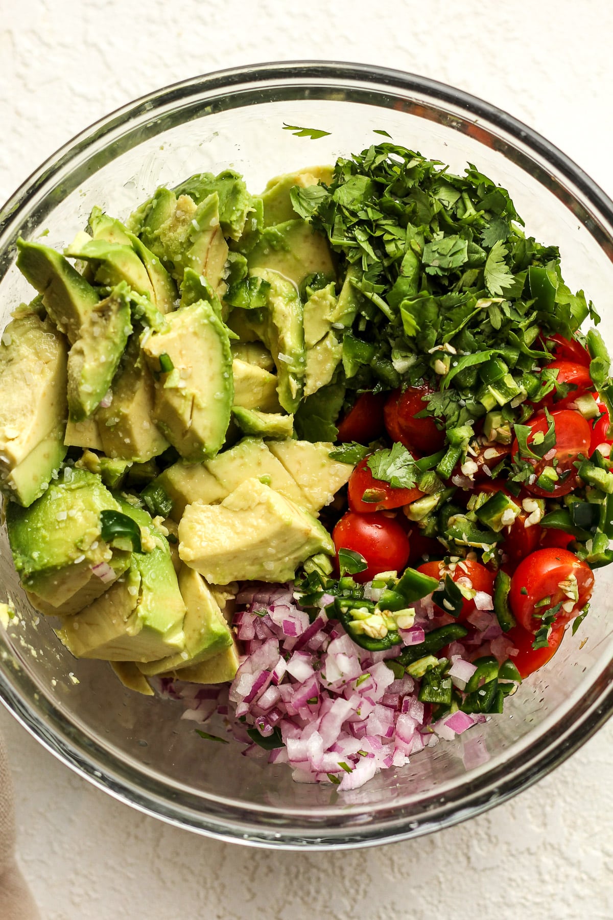 A bowl of the avocado, cilantro, tomatoes, jalapenos, and red onion.