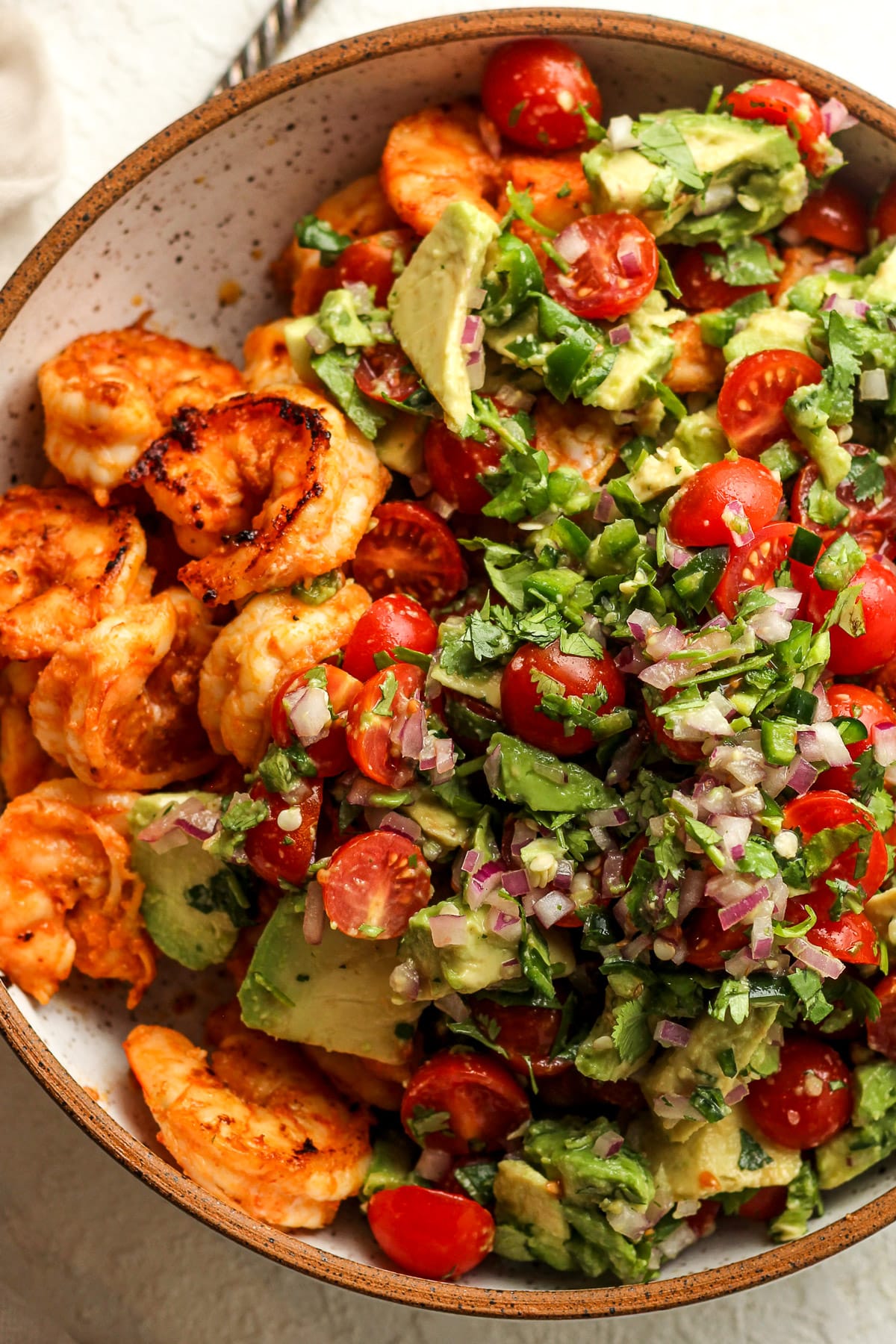 A salad bowl of the Mexican shrimp salad after adding the salad toppings.