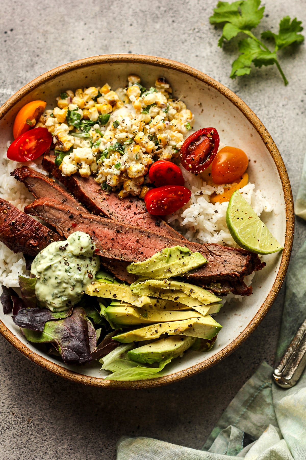 A carne asada rice bowl with avocado.