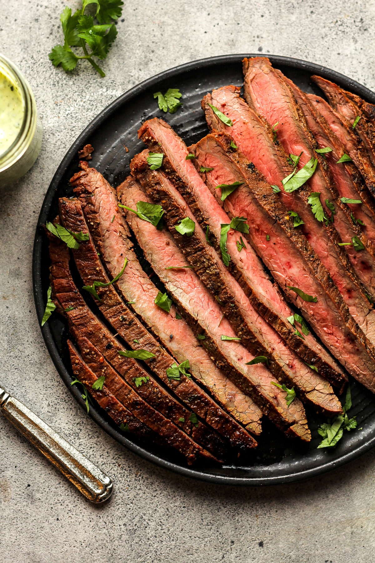 A plate of thinly sliced grilled carne asada steak.