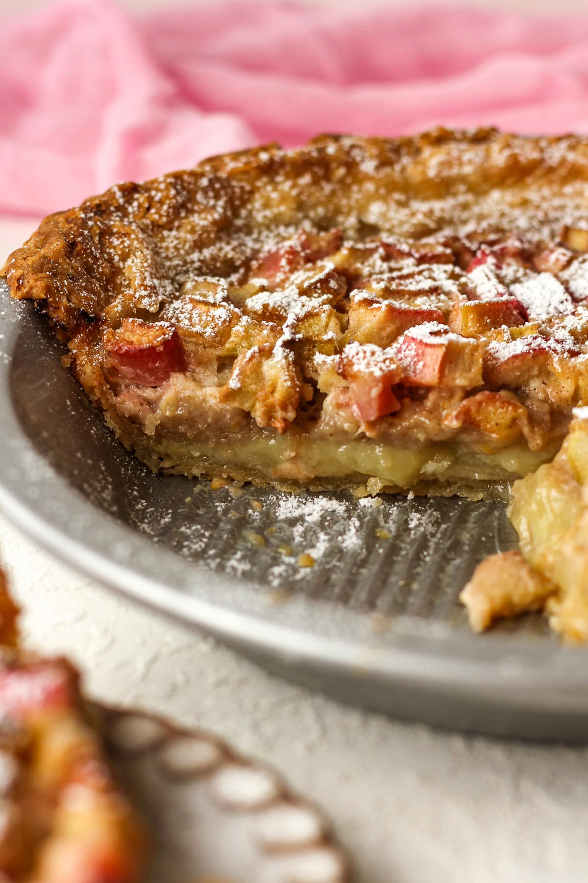 Side view of a rhubarb custard pie showing the insides of the pie.