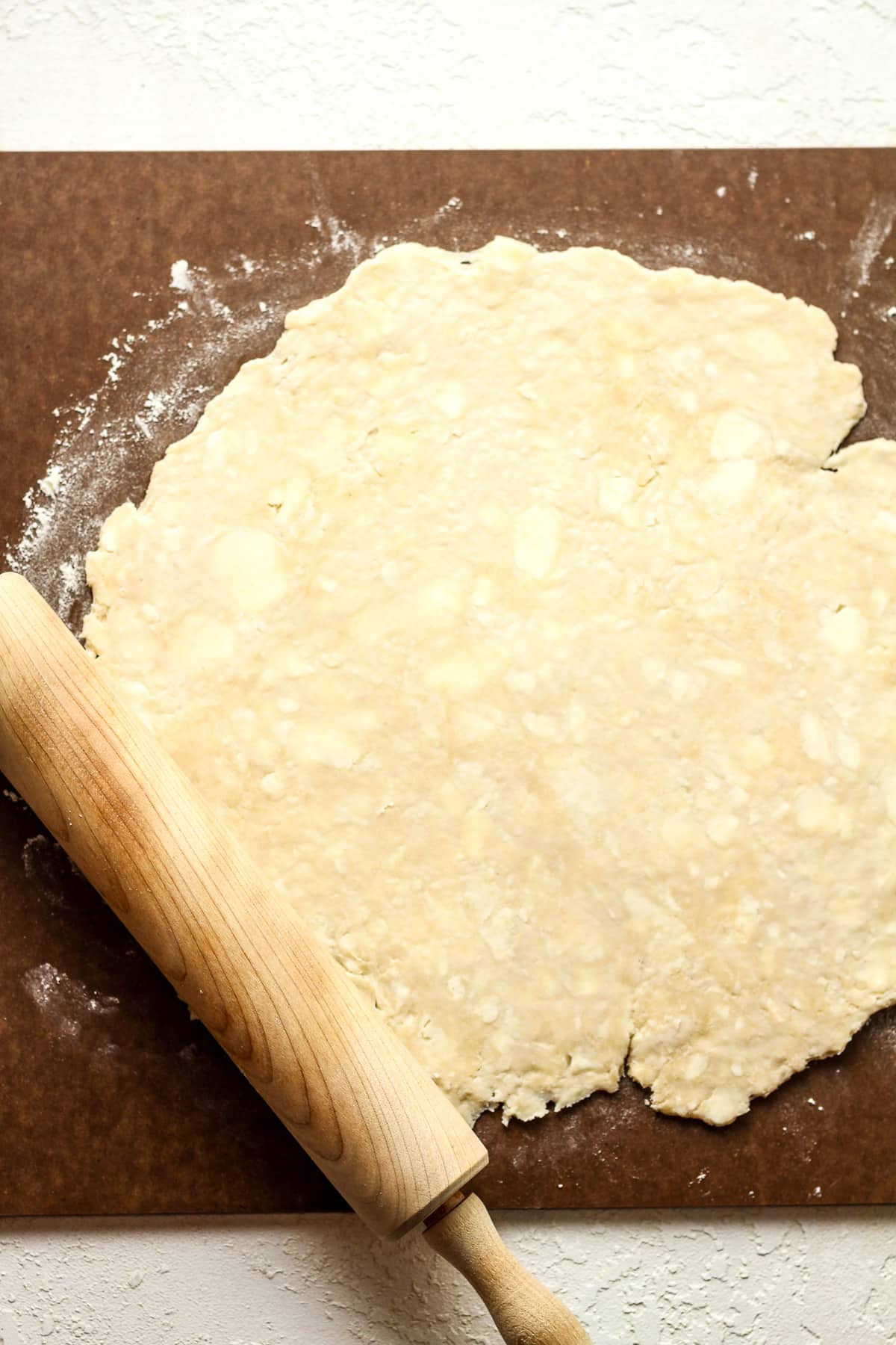 A board with a rolled out pie crust.