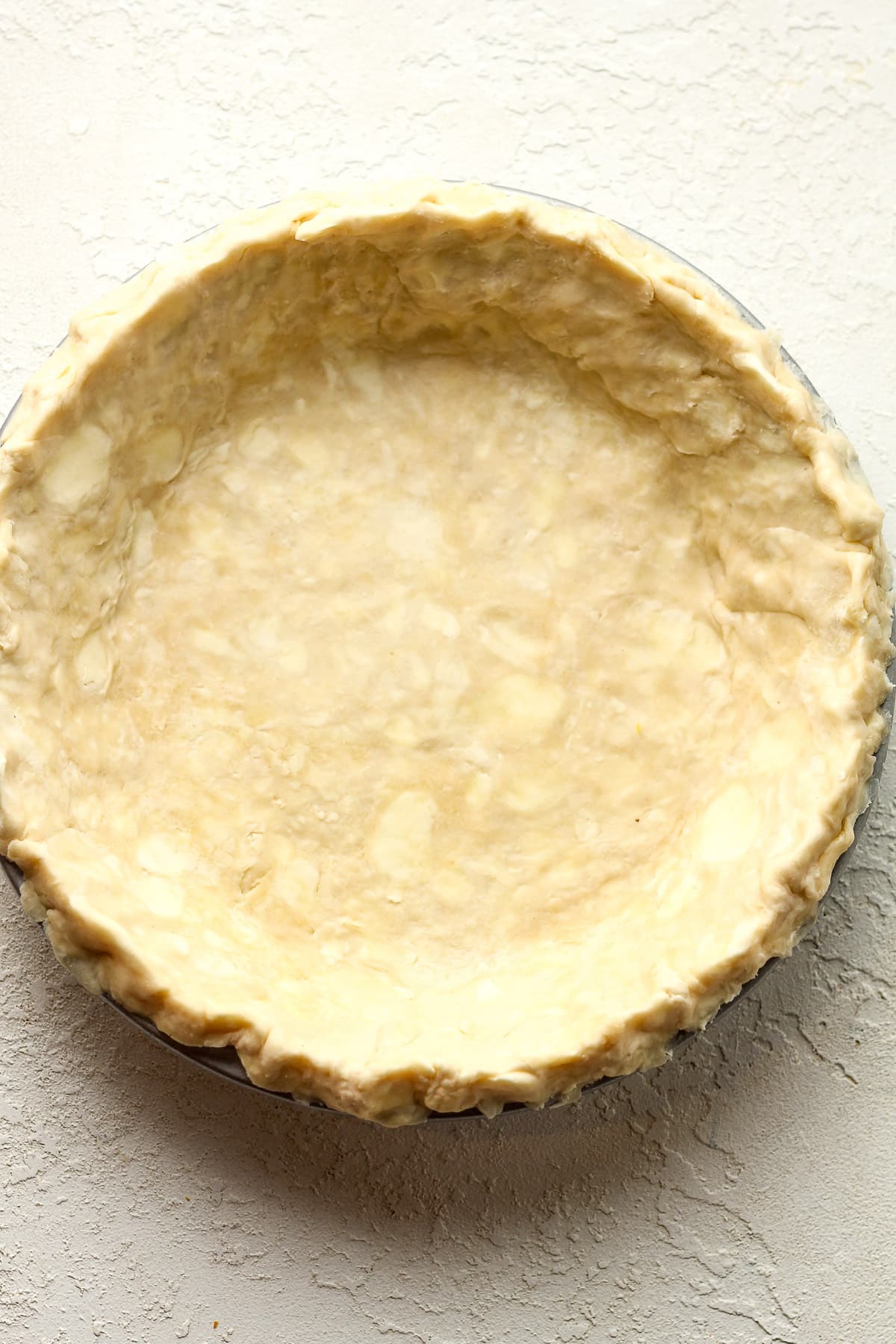 An all-butter pie crust inside a 9-inch pie plate.