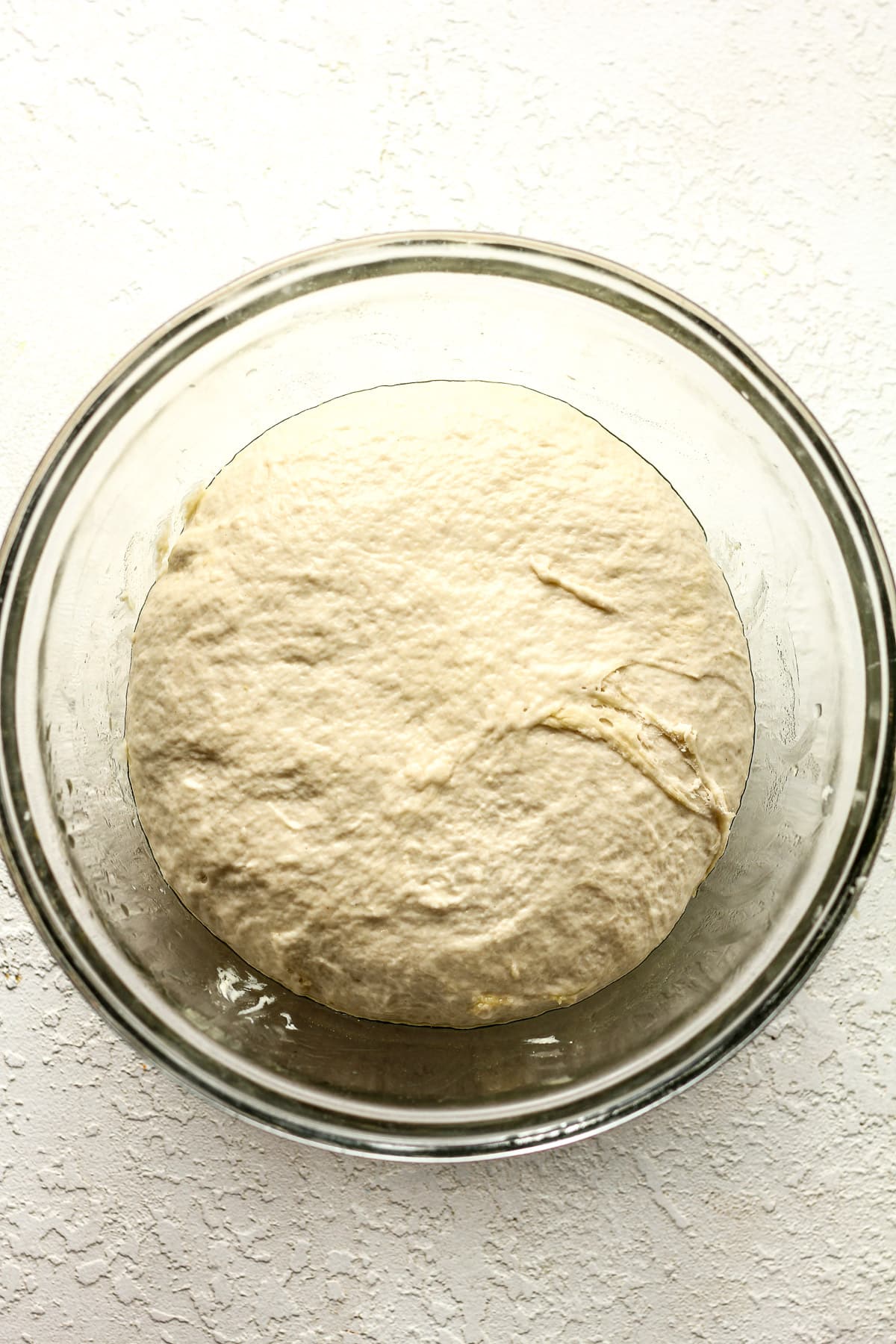 A bowl of sourdough discard pizza dough.