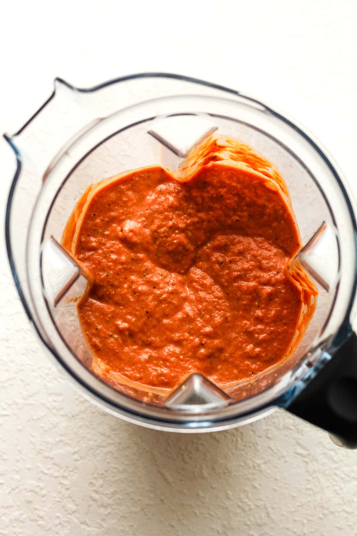 A blender with the just blended sauce.