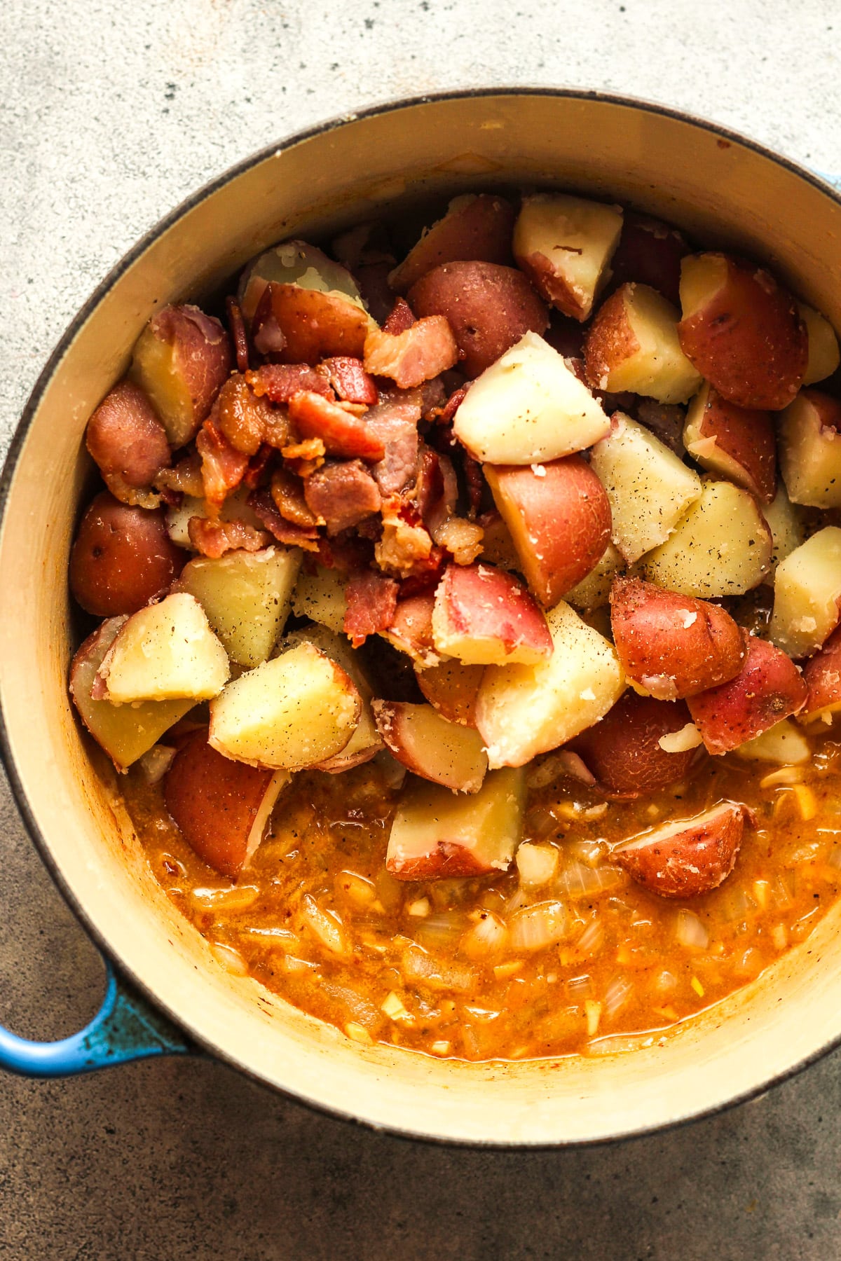 A pot of the dressing and potatoes and bacon after addint them back in.