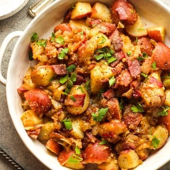 Closeup on a bowl of German potato salad with bacon.