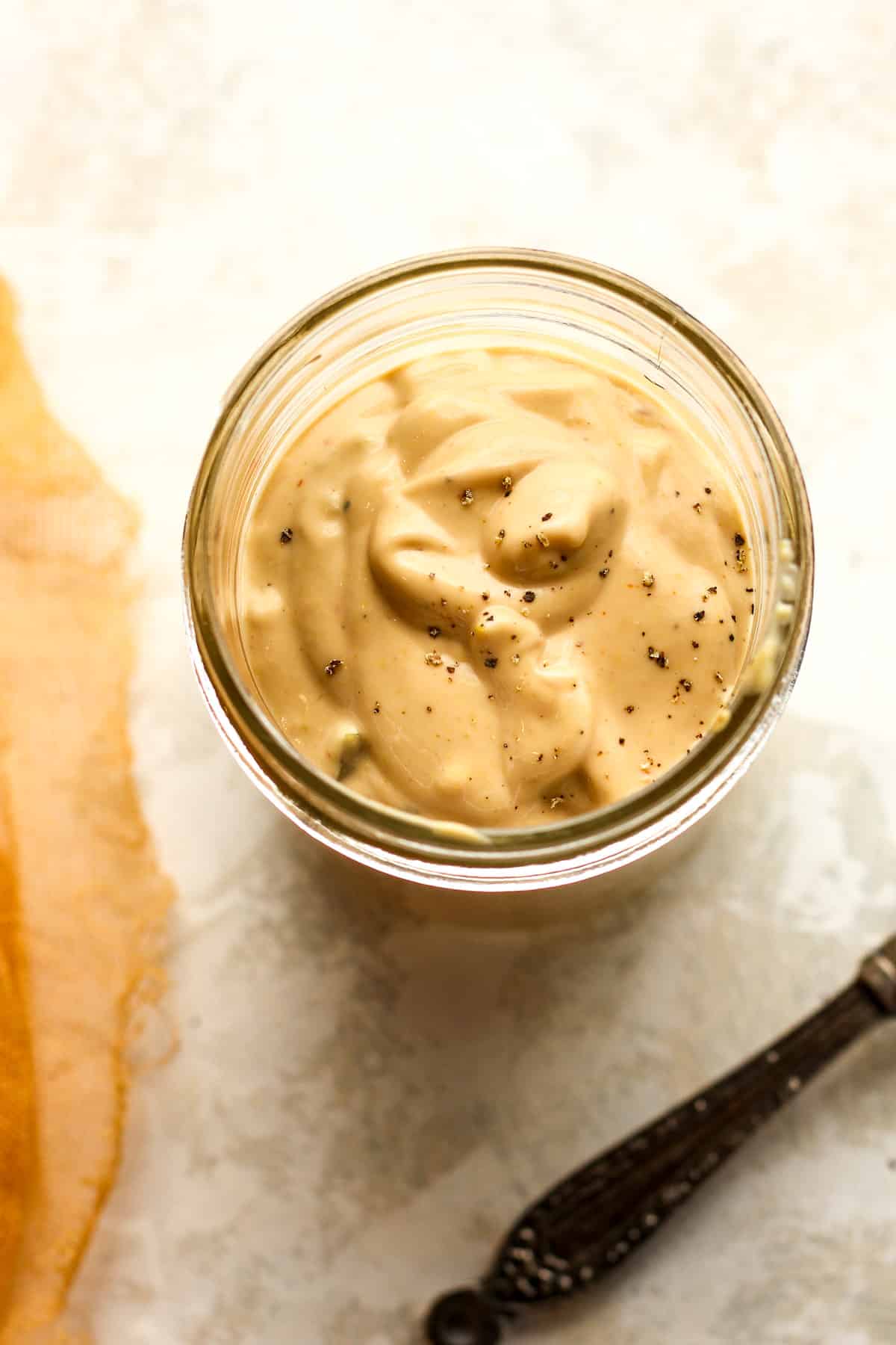 The jar of special sauce and a spoon nearby.