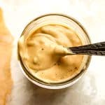 Closeup on a jar of burger sauce with a spoonful on top.