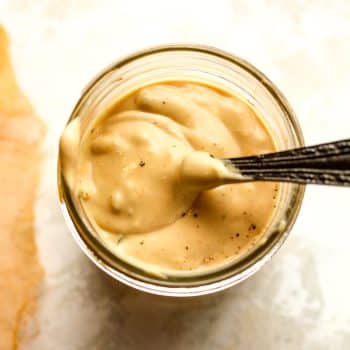 Closeup on a jar of burger sauce with a spoonful on top.