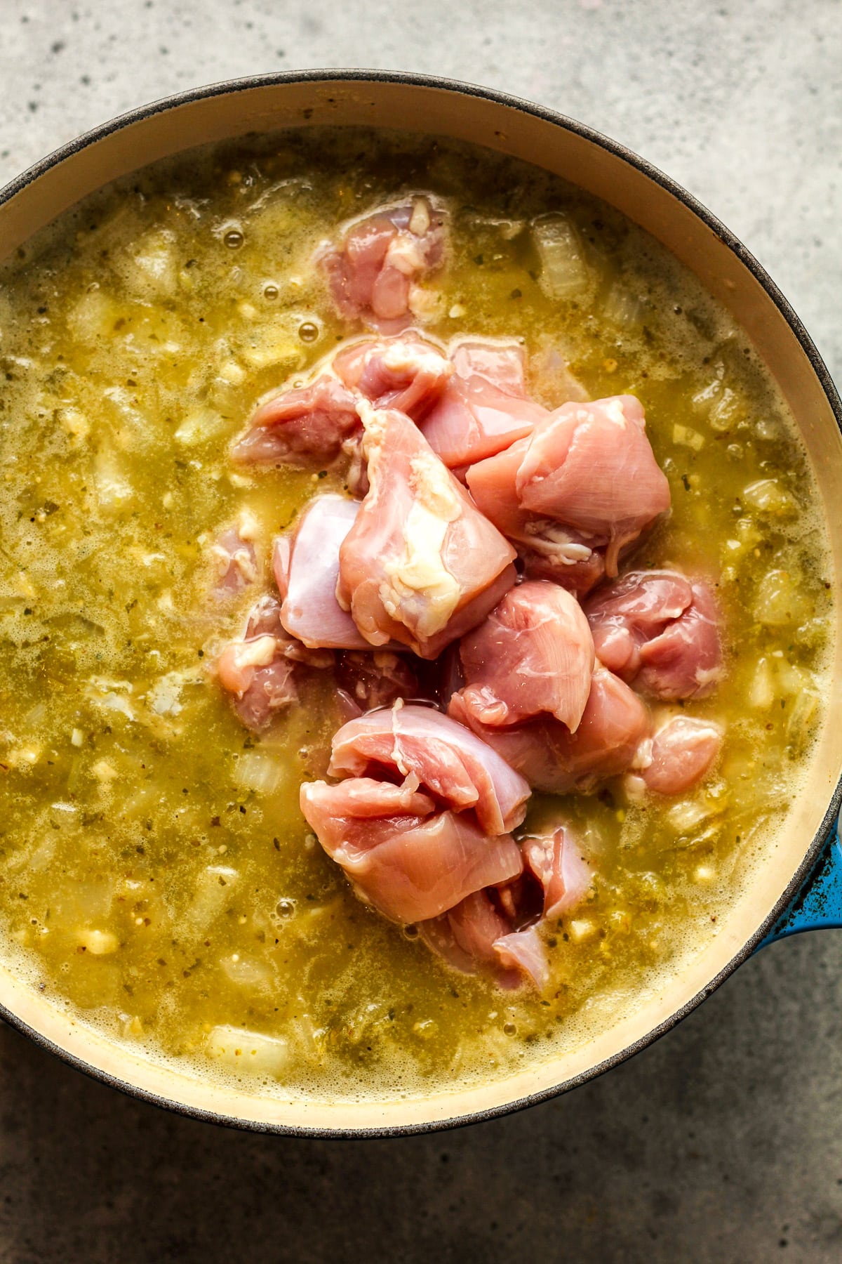 The pot of soup after adding the chopped chicken thighs.