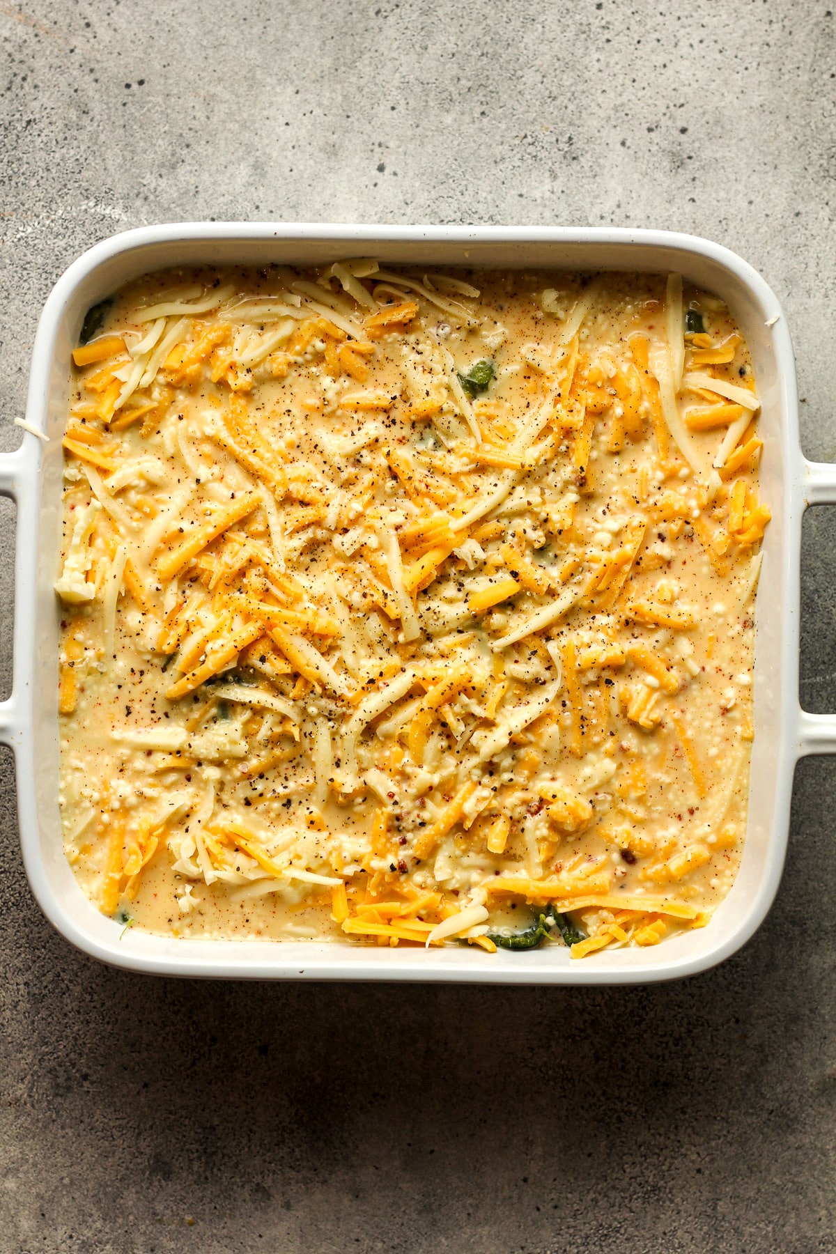 A rectangular dish of the casserole before baking.