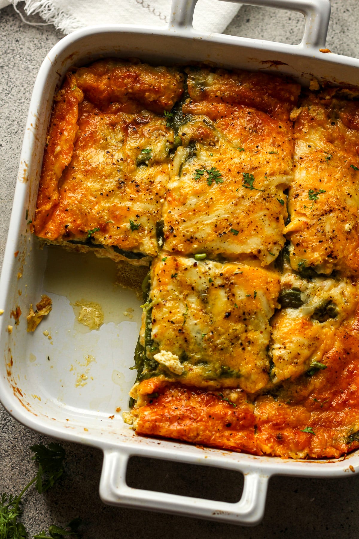 Overhead view of a square dish of chile relleno - sliced into six pieces.