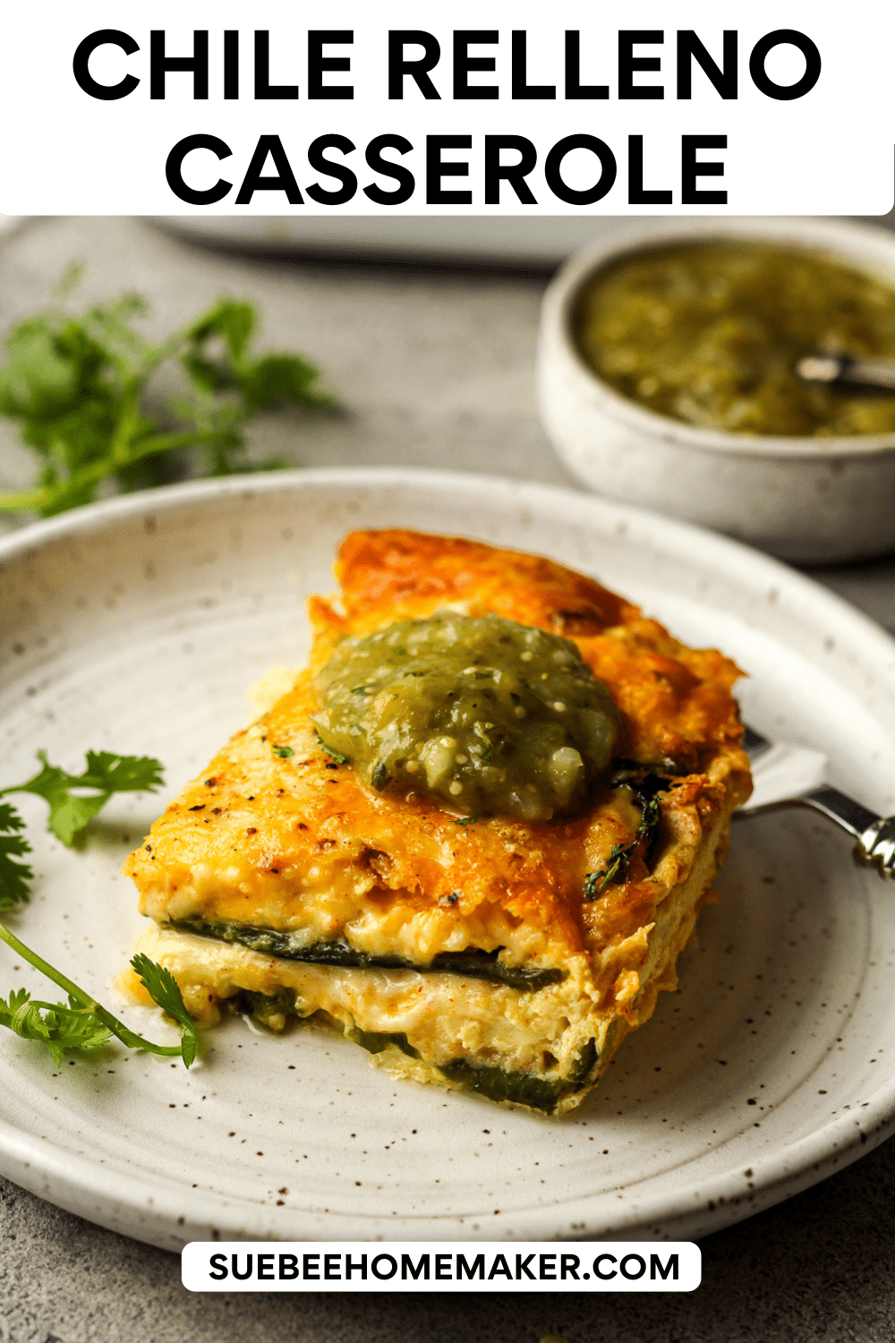 Side view of a serving of chile relleno casserole with salsa verde on top.