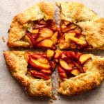 Closeup on a quartered peach galette.