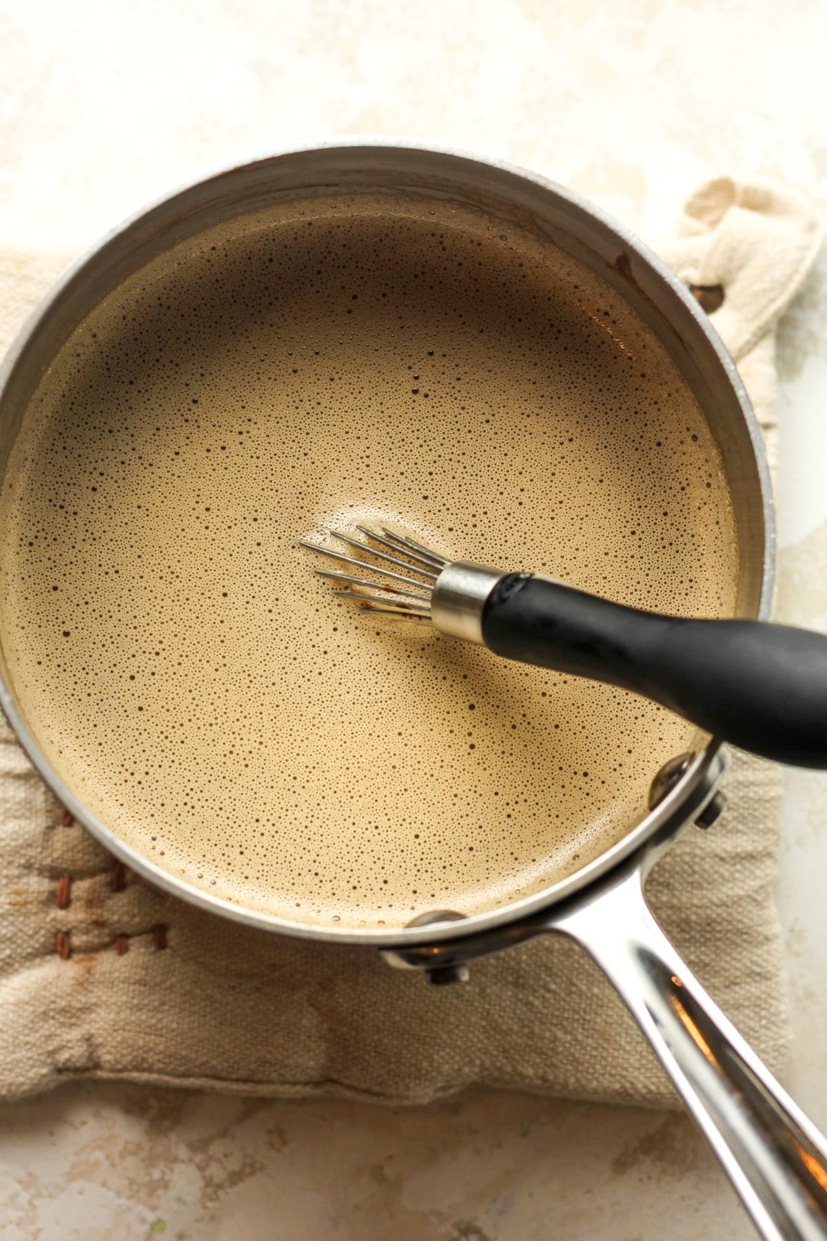 A pot of the tempered egg mixture with espresso.