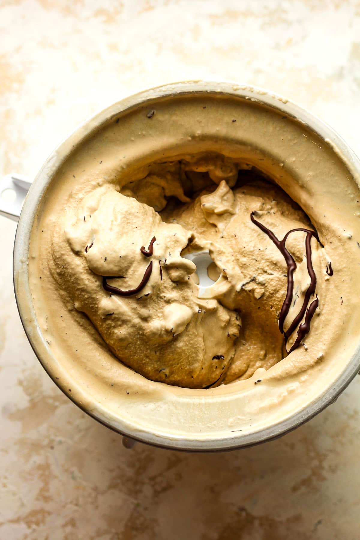 The KitchenAid ice cream attachment with espresso stracciatella ice cream after churning.