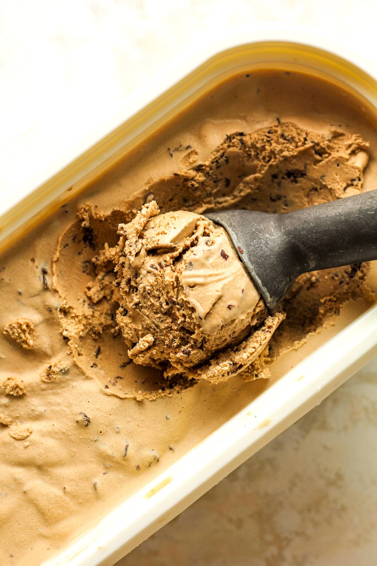Overhead view of an oblong container of espresso stracciatella ice cream.