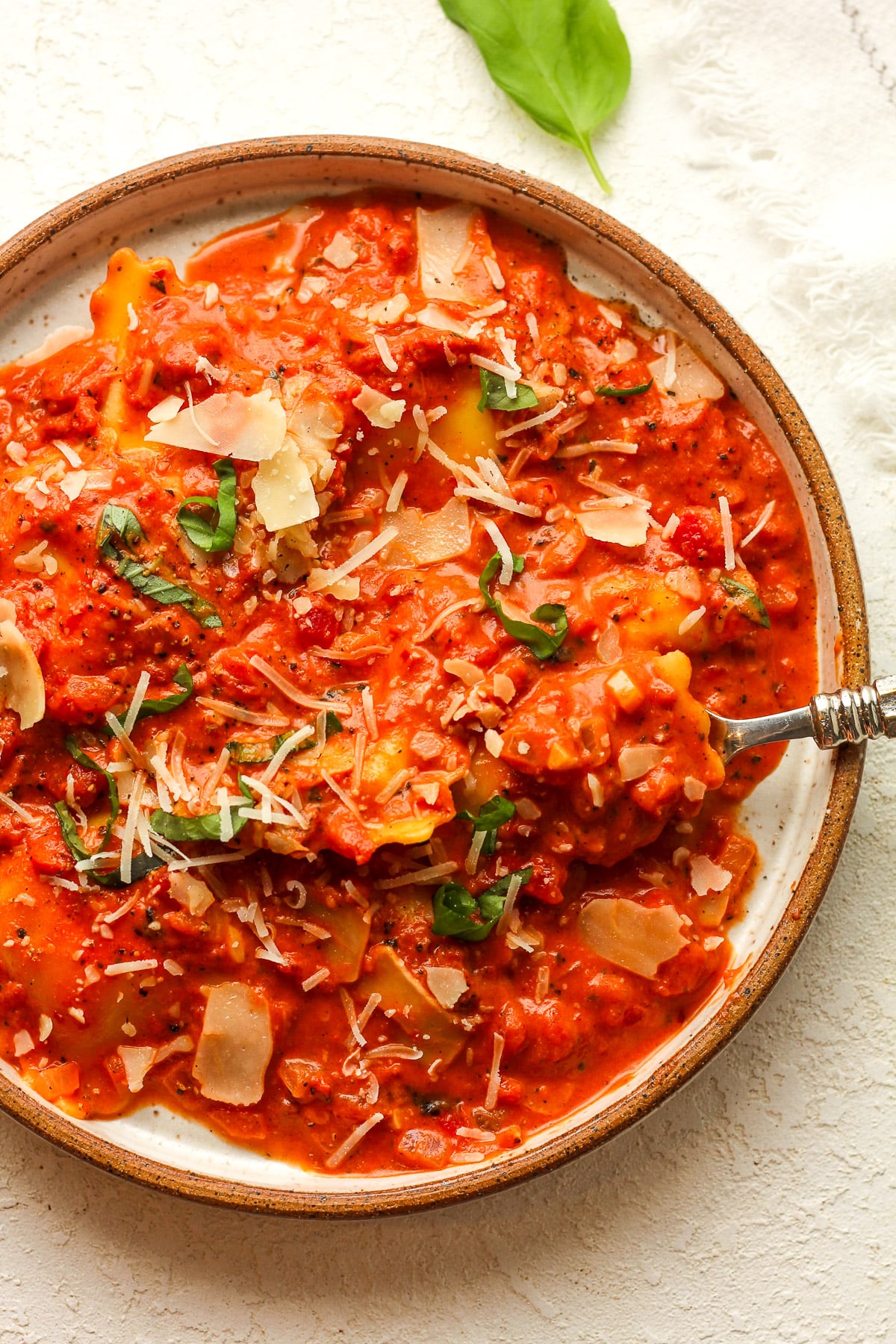 A serving plate with ravioli alla vodka with a fork.