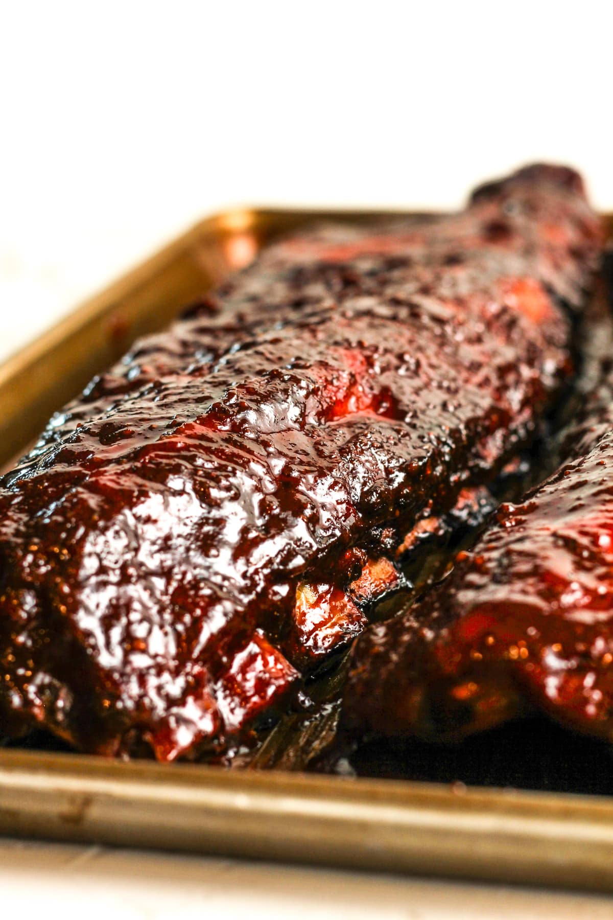 Side view of the racks of ribs after adding the barbecue sauce.