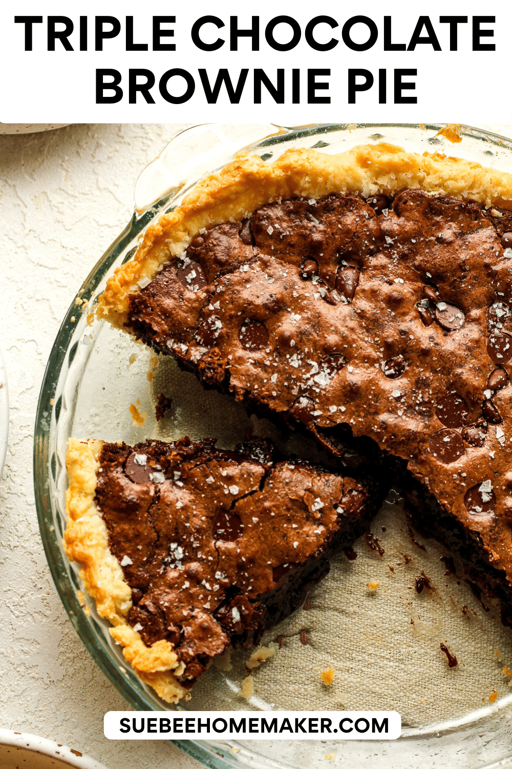 Overhead view of a glass pie plate with a triple chocolate brownie pie - sliced.