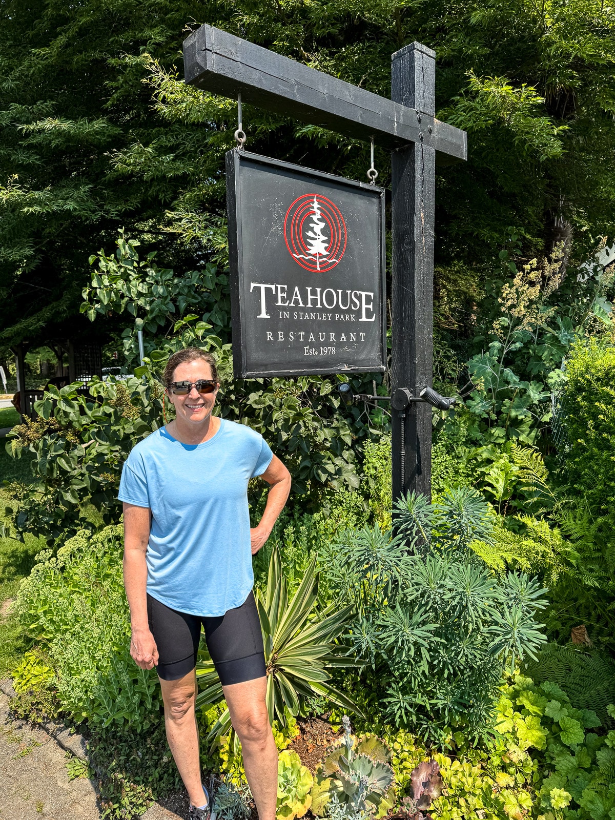Sue by the Tea House sign in Stanley Park.