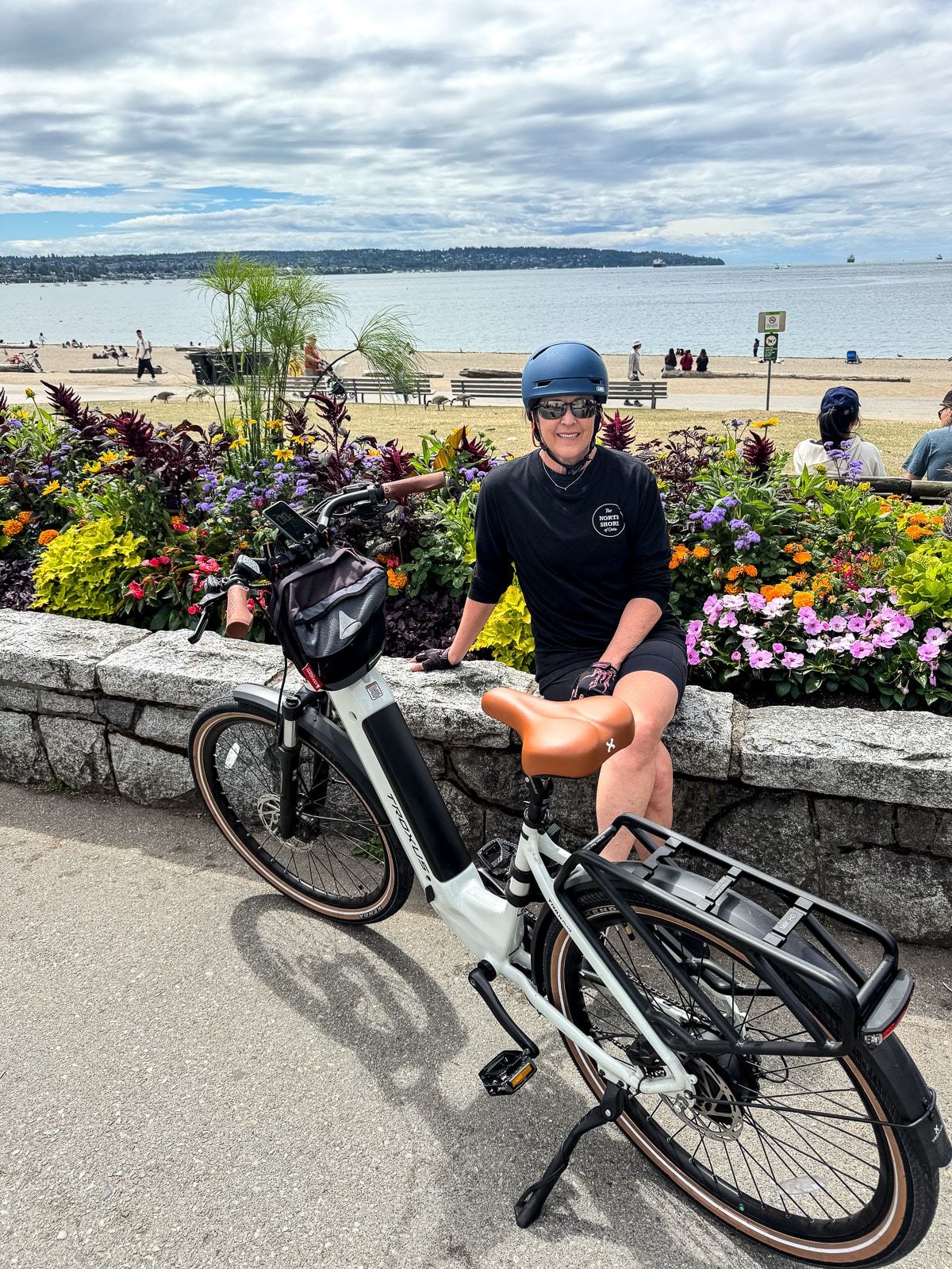 Sue sitting on the sea wall in downtown Vancouver at the beach.