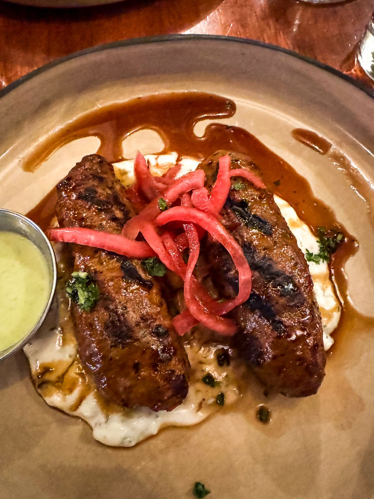 Sausage on a plate with sauce at Nuba.