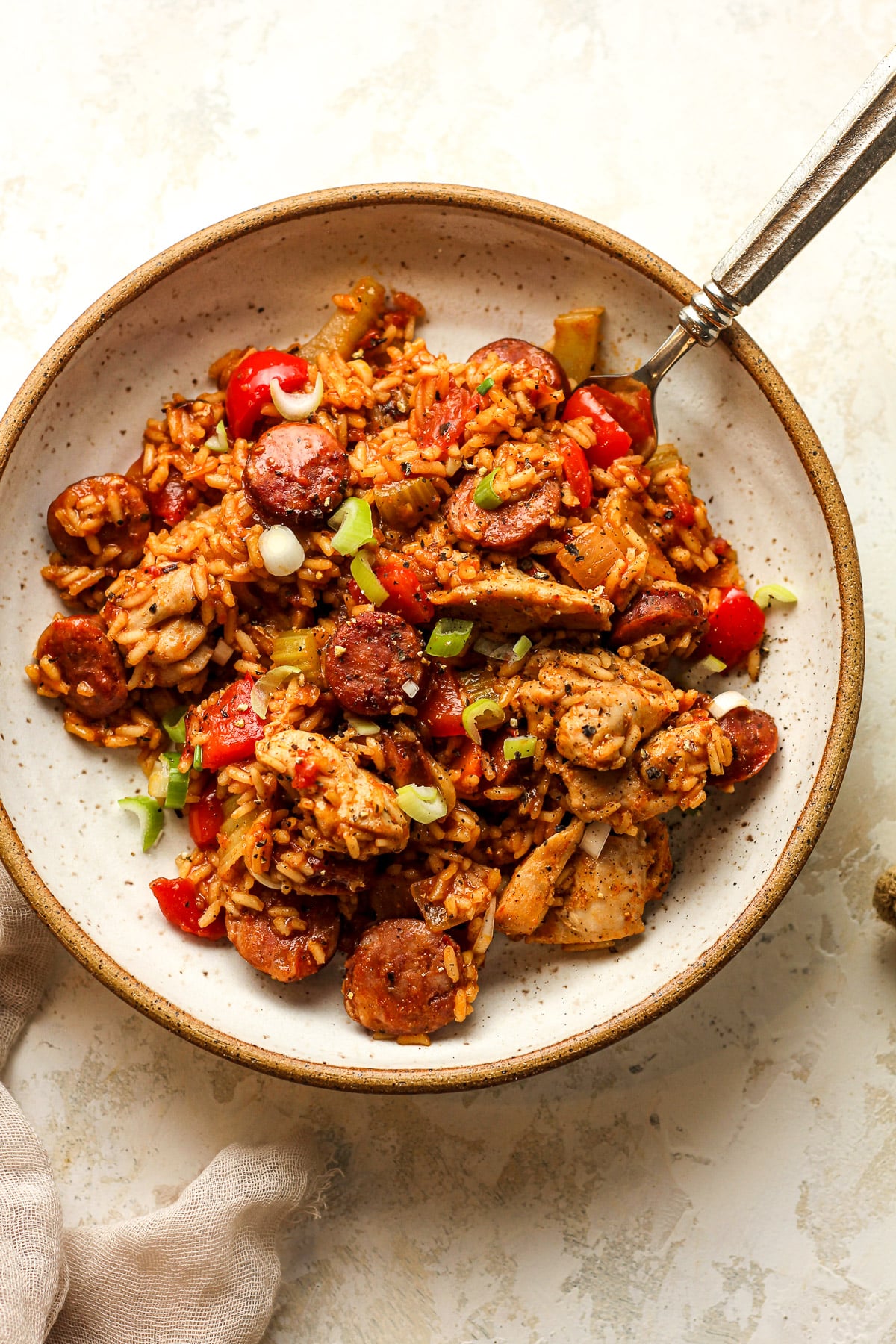 A bowl of jambalaya with chicken and sausage.