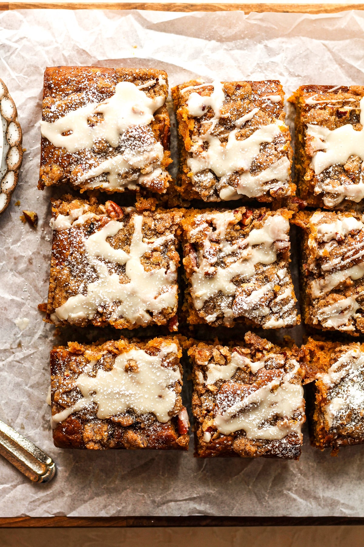 A board with some sliced pumpkin crunch coffee cake.