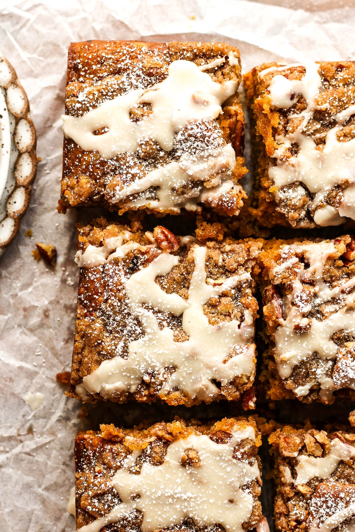 Closeup on some sliced pumpkin crunch coffee cake with a simple glaze.