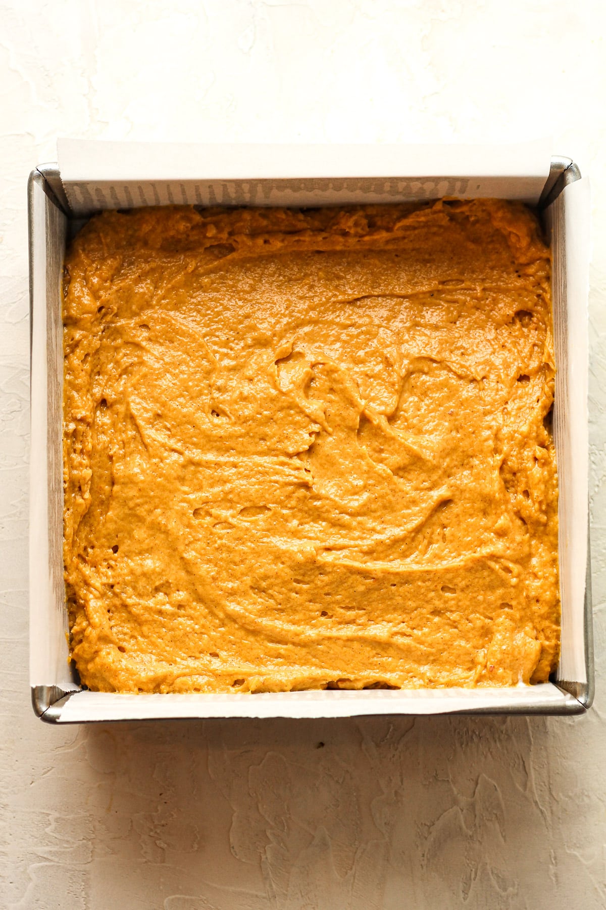 A pan of the pumpkin cake batter.