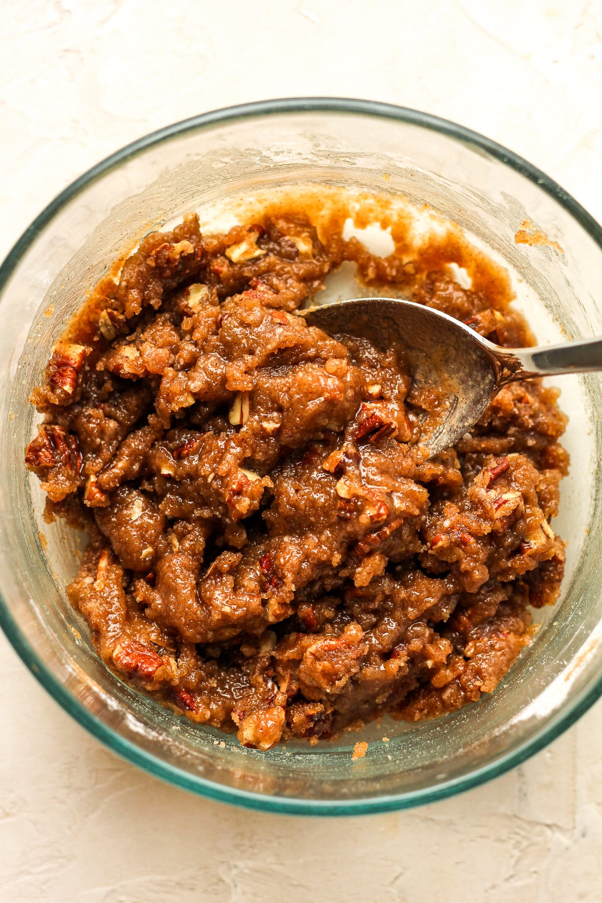 A bowl of the crunch topping with melted butter.