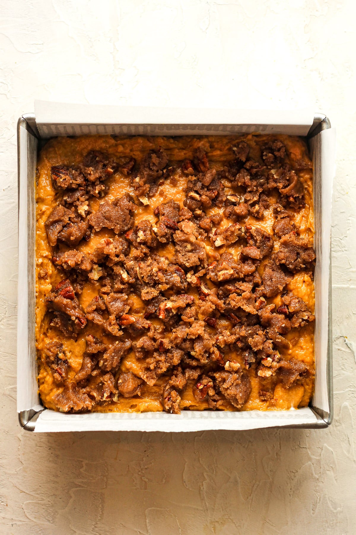 A pan of the pumpkin batter with the crunch on top.