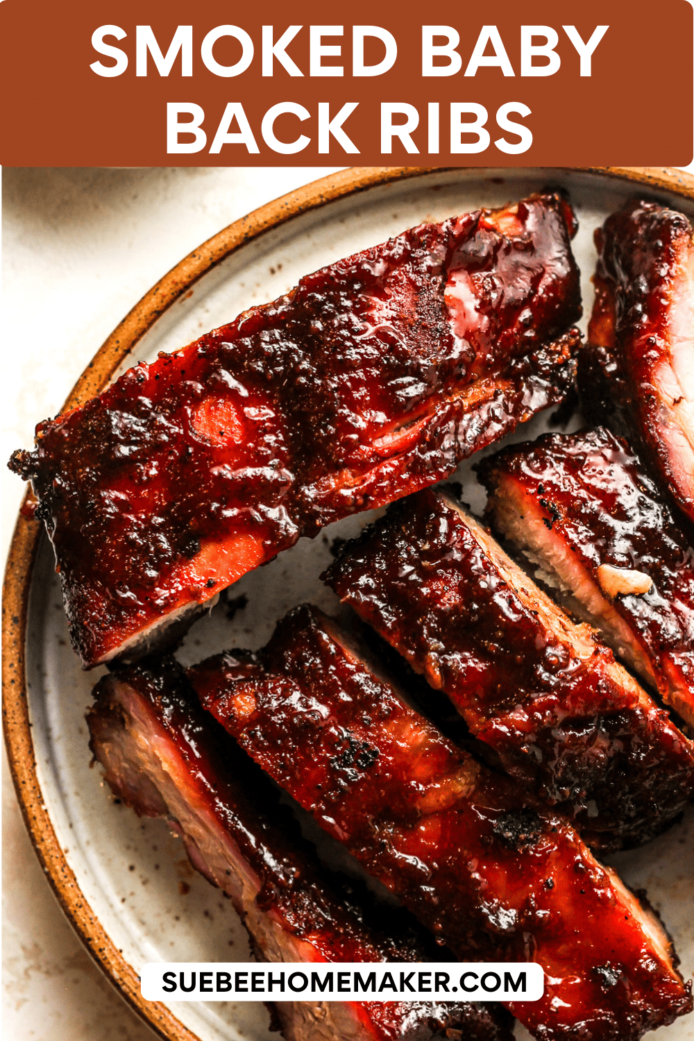 A plate of smoked baby back ribs with barbecue sauce.