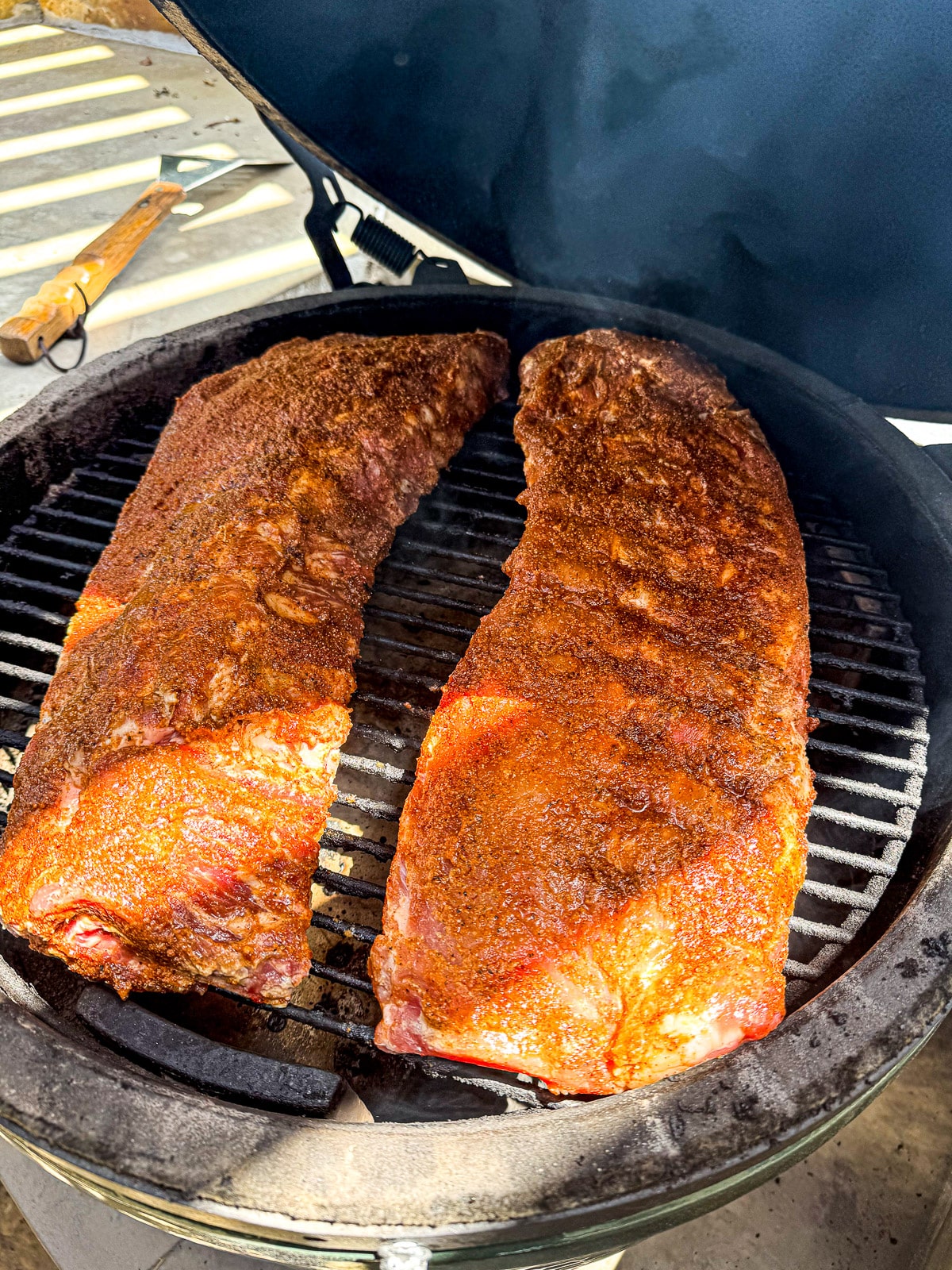 The marinated ribs on the grates of a BGE.