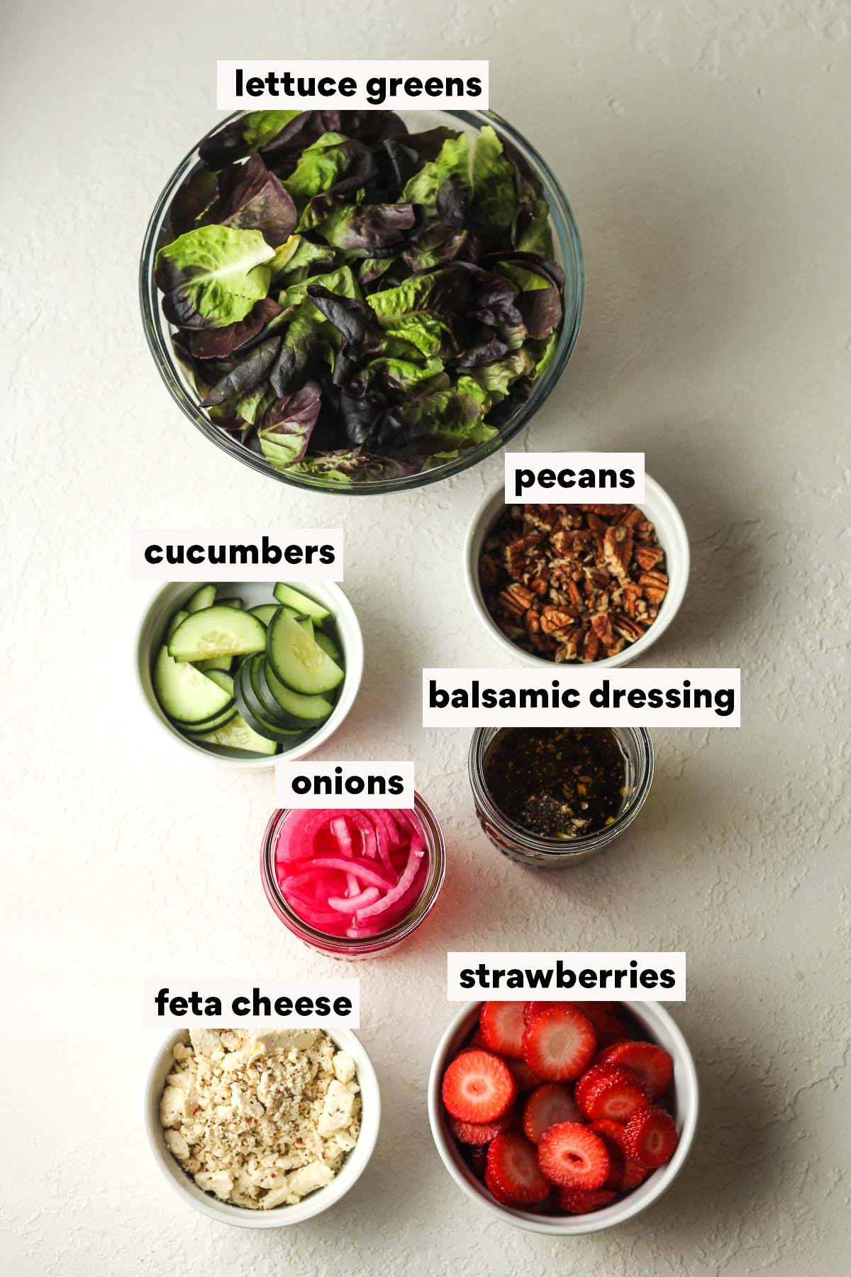 Labeled ingredients for strawberry feta salad.