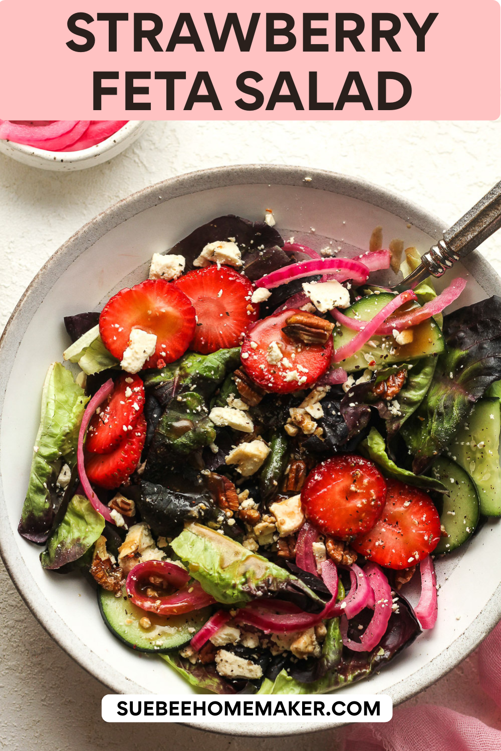 A serving of strawberry feta salad with honey balsamic dressing on top.