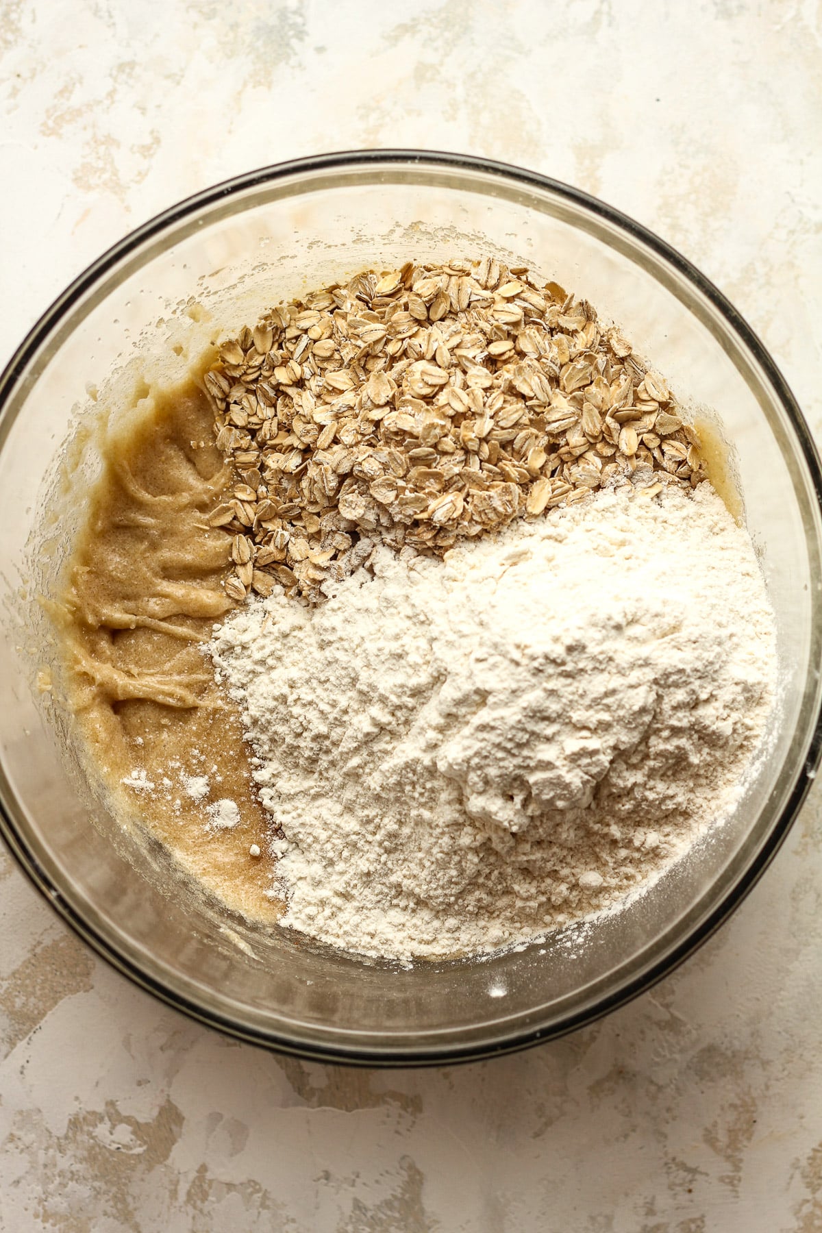 A bowl of the wet ingredients topped by the dry ingredients.